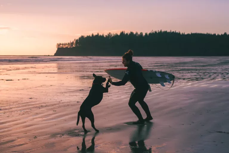 Mitch on a beach with his pup
