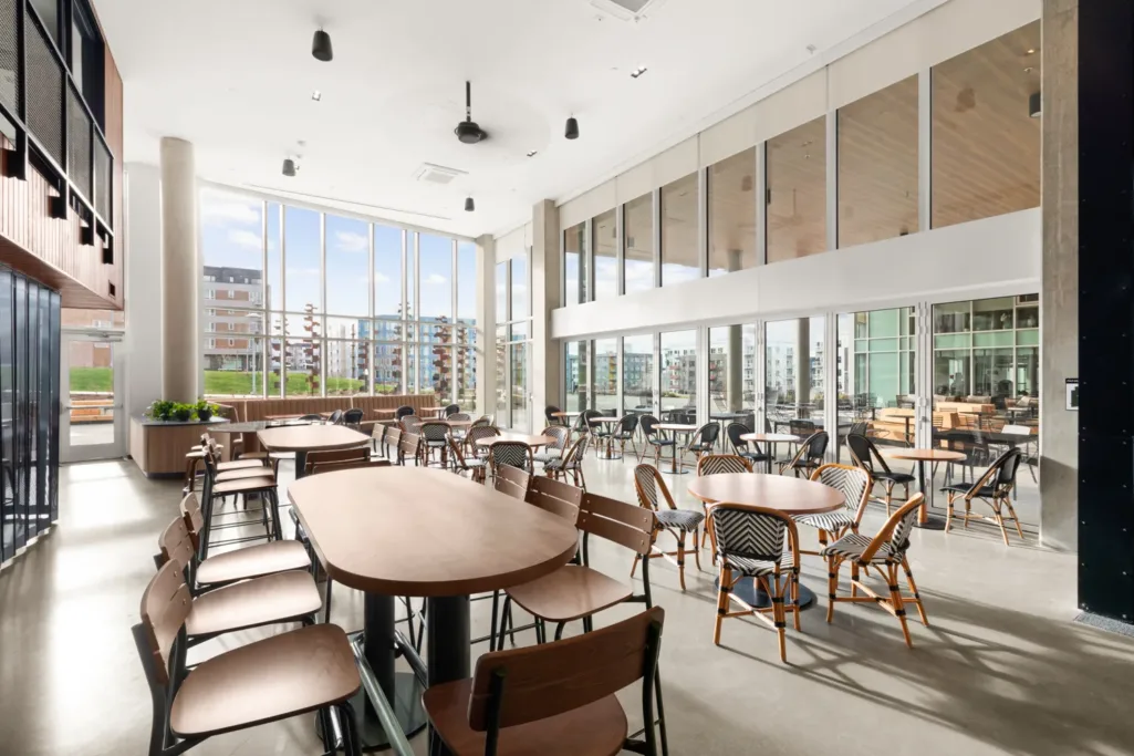 Long table in well lit room with lots of windows